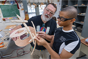 teacher and student working on sculpture