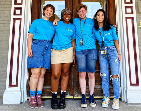 student life workers standing in front of admissions building front door